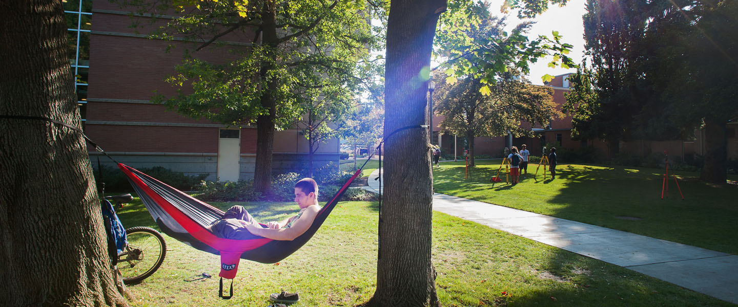 Student in hammock on campus