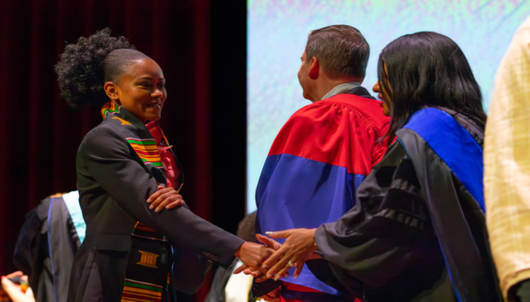 Graduate shakes hand with admin