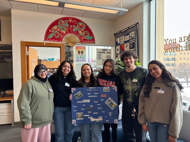 Students pose with their black out poetry poster