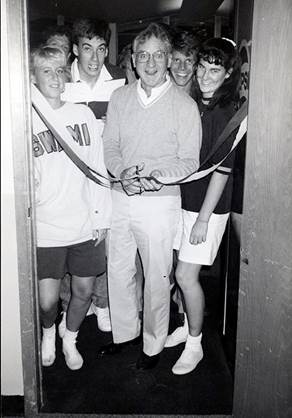 Father Coughlin cutting a ribbon