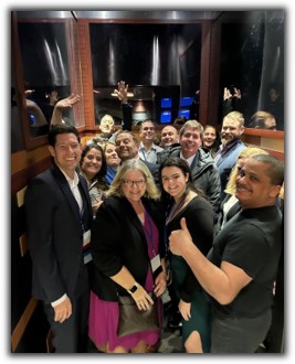 Alumni and staff in a crowded elevator