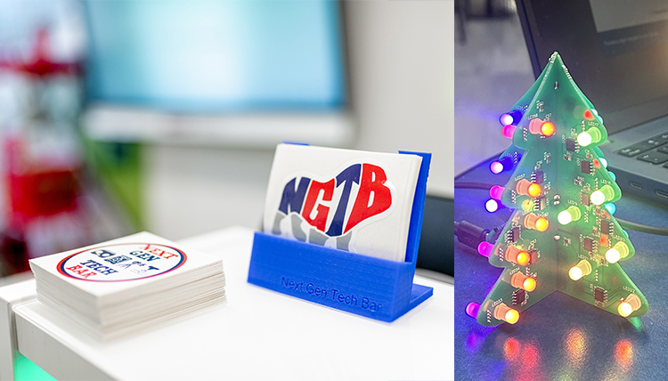 Business cards for the Next Gen Tech Bar sit on a desk next to a picture of a mini Christmas tree.