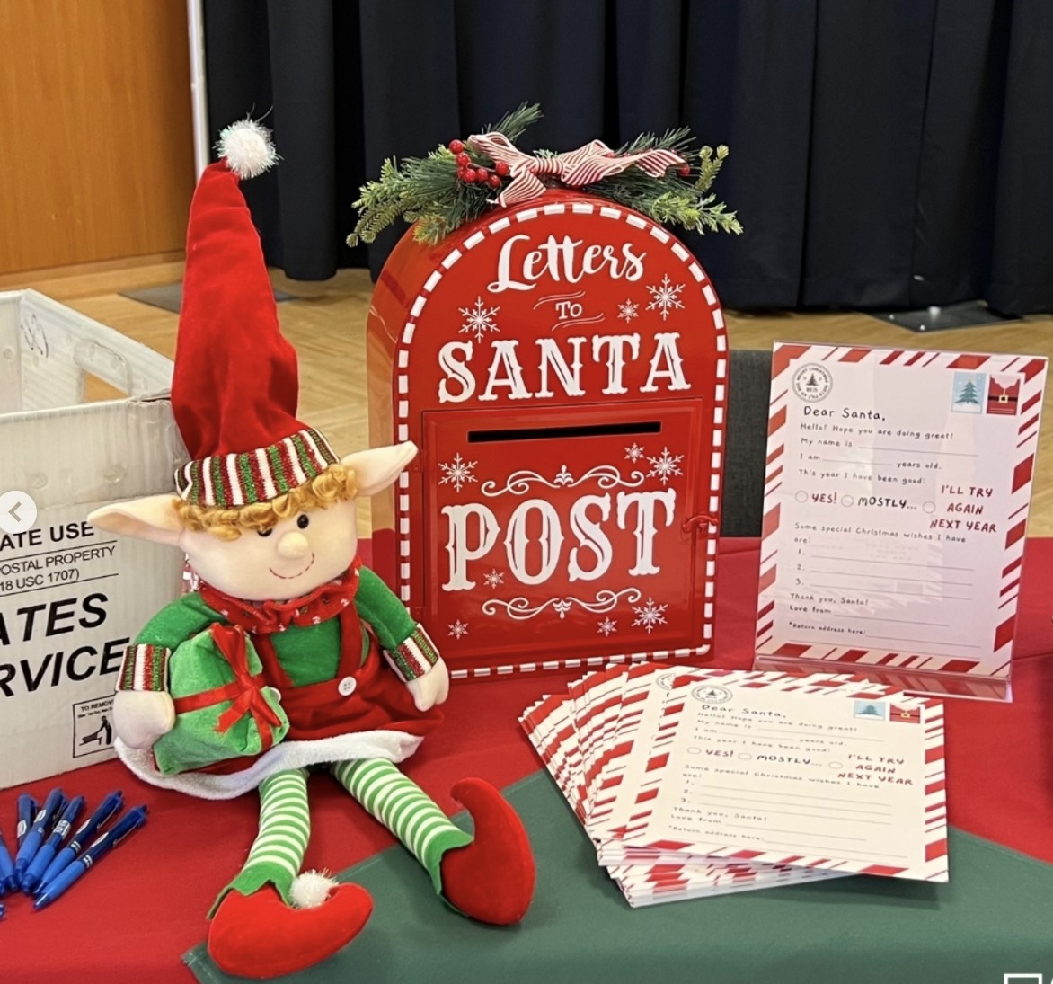 Stuffed elf next to Santa letterbox