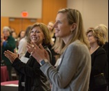 woman at conference, clapping 