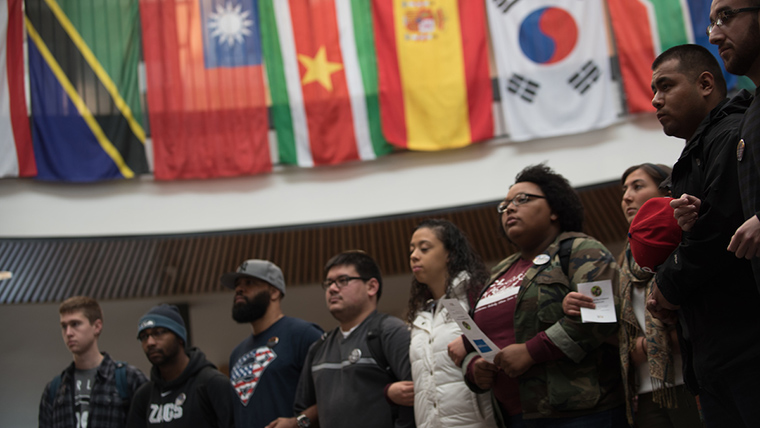 Students stand linked together in the Hemmingson Center.