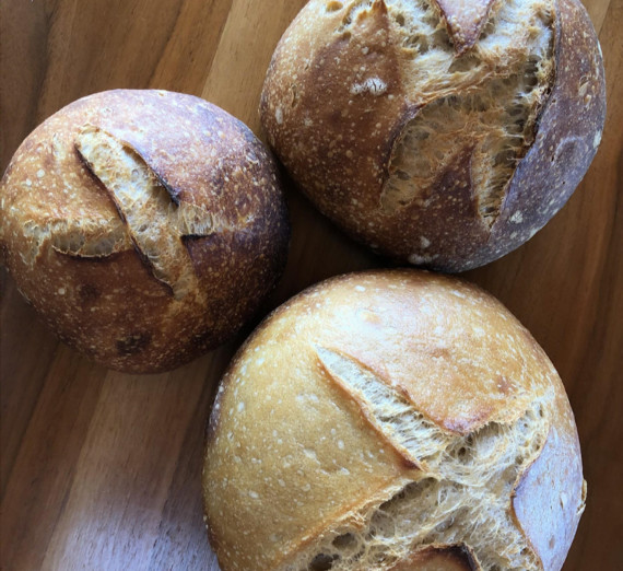 Three loaves of bread on a table made in Professor Mat Rude's Ceramics course.