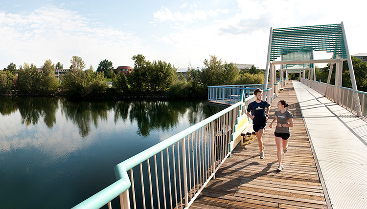 Students running on bridge across Spokane River