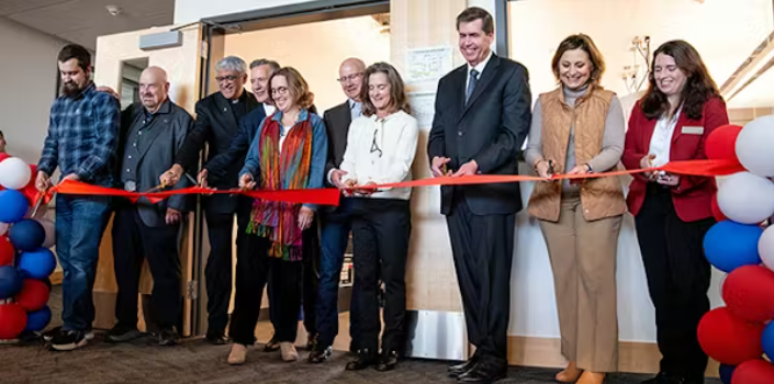 Line of people behind ribbon cutting for Patrick Ferro Center for Materials Research opening