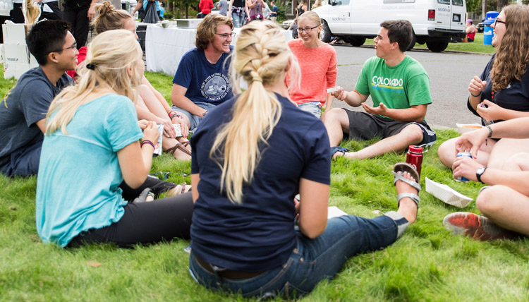 Students talking at Logan neighborhood block party