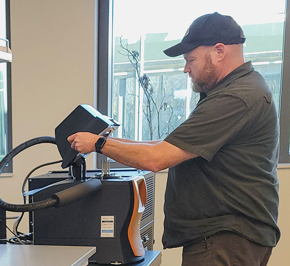 Scott Economu loads the mechanical analyzer