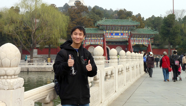 Study Abroad student posing for a picture at a building in China