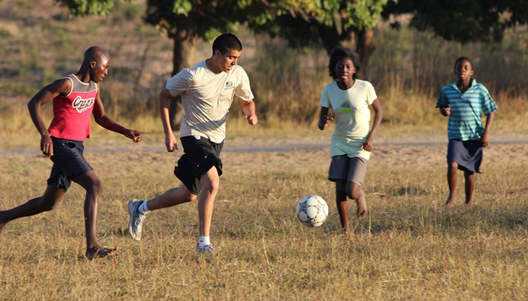 Study Abroad student playing soccer in Zambezi