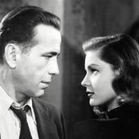 Up close image of the lens of a vintage film projector playing a video. 