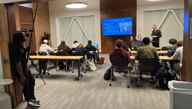 C-SPAN camera crew filming Gonzaga University History Department lecture on Jimmy Carter’s Cold War policies, with Professor presenting to students in a classroom setting.