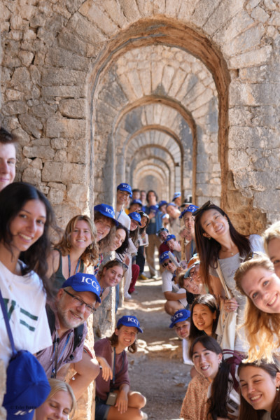 Gonzaga University students explore ancient Roman architecture during the ICCS study abroad program in Italy, guided by a Gonzaga history faculty member. The group is standing under a series of stone arches at a historic archaeological site, showcasing Gonzaga’s commitment to global education and immersive learning experiences.