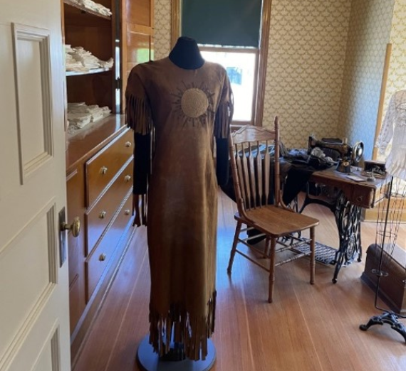 Sewing room at the Campbell house with sewing machine and dress on mannequin. 