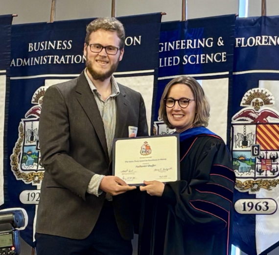 Nathaniel Shaffer with Dean Jacquie Van Hoomissen of the 91 College of Arts and Sciences holding an award at the 2025 Academic Honors and Magis Student Achievement Awards