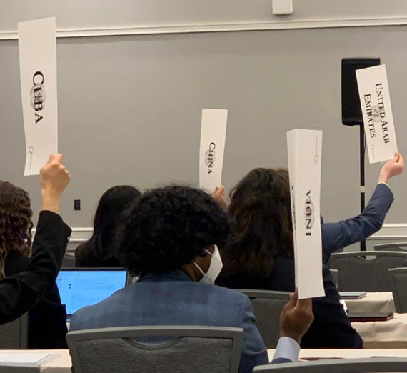 Model United Nations students holding up placards with country names on them.