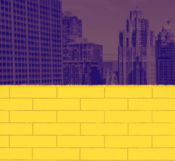 A cityscape in the background with a yellow wall in the foreground. 