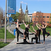 Student dancers outside on campus.