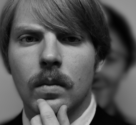 A close up shot of a man's face in black and white.