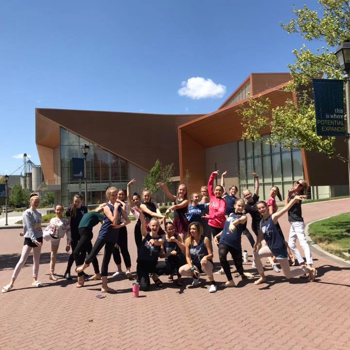 Dancers posing in front of performing arts center
