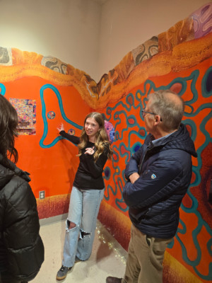 Ava Knap, Art and Neuroscience student discussing her exhibit 