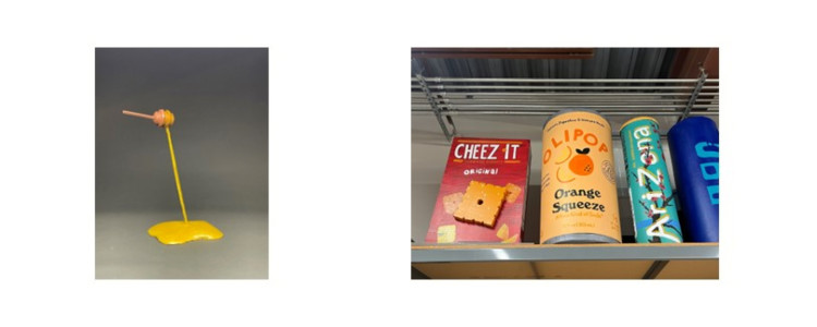 3D sculptures-a honey dipper dripping a pool of honey, and a box of crackers and three drink cans.