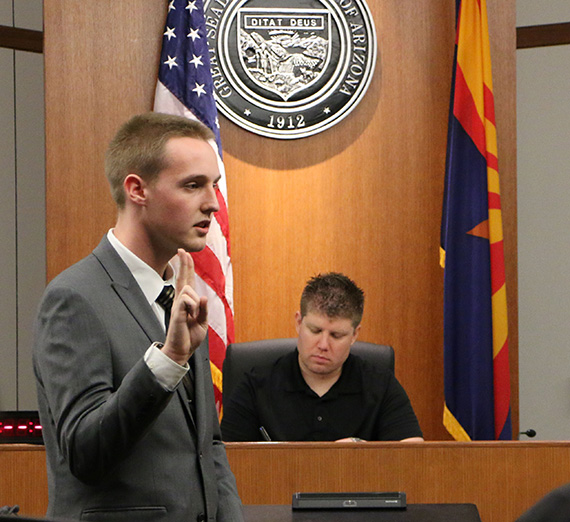Kurt Wohlers stands in front of a mock trial court room.