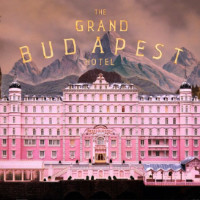 The Grand Budapest Hotel Movie Poster with a hotel in the mountains and the movie title at the top.