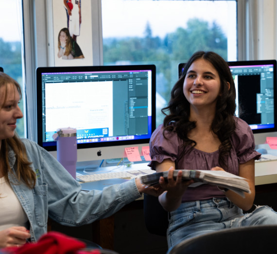 Two students smiling in class.