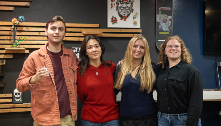 Students Joseph Deaser, Grace Applebaum, Carrera Guertin, and Nelia Wood pose after reading their creative writing at Paper Street Coffee Co. Featured writer Leyna Krow, author of Fire Season joined the event facilitated by faculty members Miranda McLeod (ENGL) and Jenny Davis (INMD). 