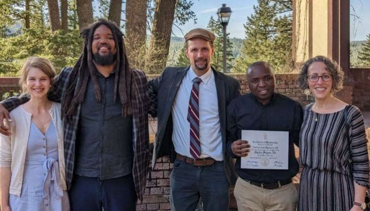 Alpha Sigma Nu honorary faculty inductees include Dr. Kendall Fisher, Dr. Darian Spearman and Fr. Lawrence Kyaligonza, SJ. Dr. Dan Bradley (center), and Dean Annmarie Caño, Ph.D., furthest left.