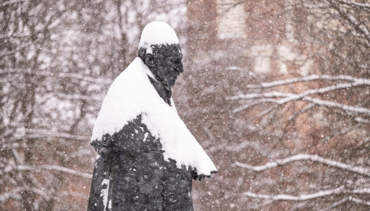 Statue of St. Ignatius covered in snow.