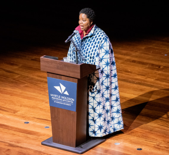 Patrisse Cullors speaking at a podium
