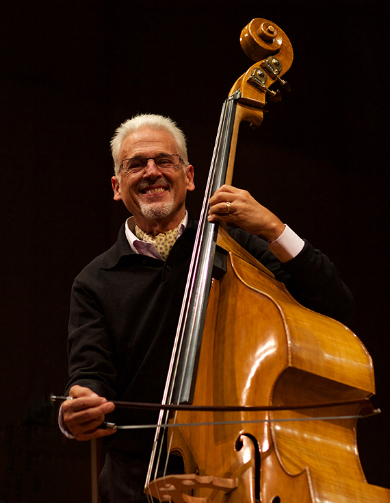 Musician Gary Karr stands next to his double bass.