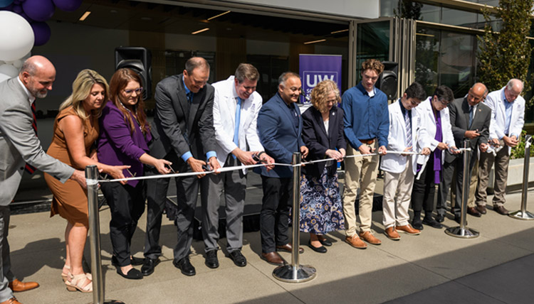 Representatives of the UW, GU, and the Spokane community cut the gauze to signify the opening of the new Health Partnership building in 2022. 