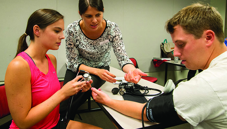 First-year medical students learning how to peform vitals on their first day of instruction in Spokane-WWAMI.