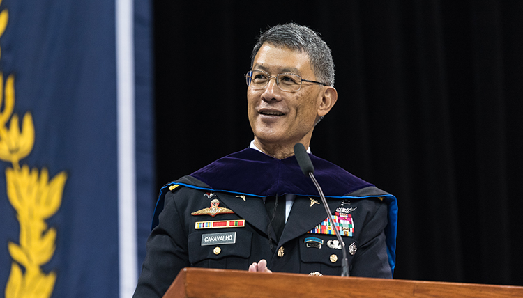 Joseph Caravalho in Army dress blues with markings of an officer, at the podium