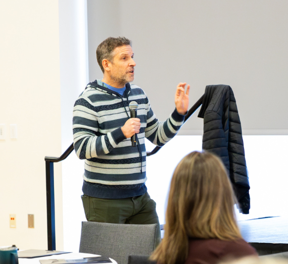 Dr. Paul Gorski speaking in front of crowd