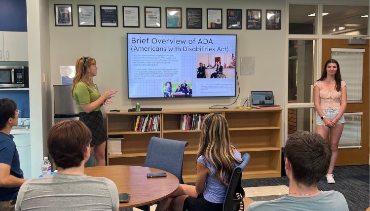 Two students present at a community event