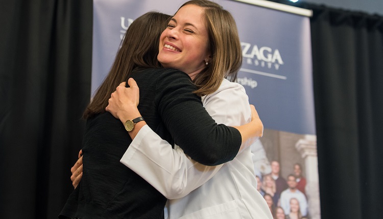 Family and friends join together to watch the newly admitted UW and Gonzaga University joint students receive their white coats on September 2nd, 2016 in the Hemmingson Center Ballroom at Gonzaga University.