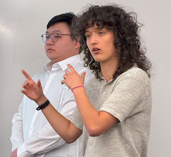 Student talks and points at screen