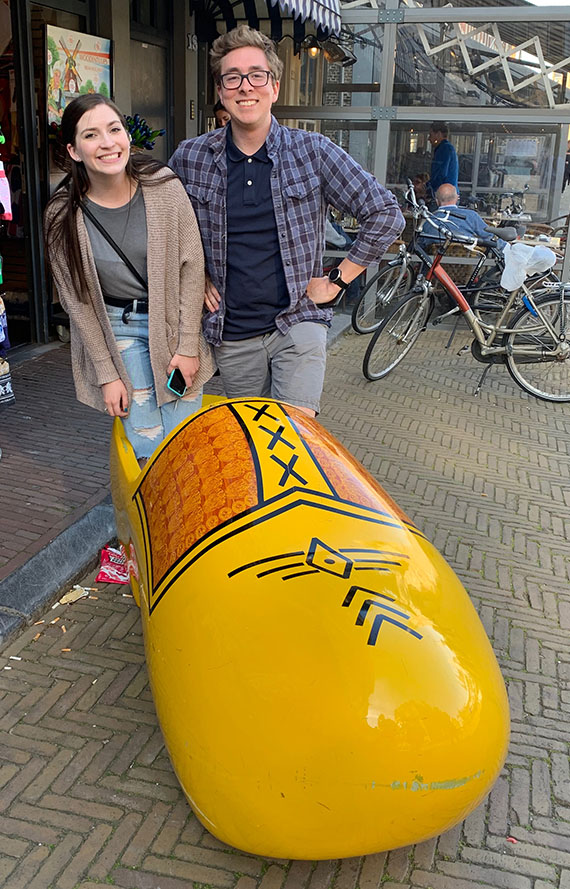 two students in large wooden shoe
