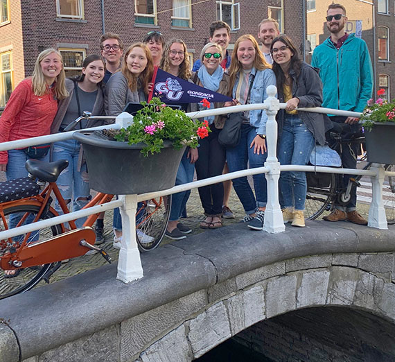 Students pose on a bridge in Delft, the Netherlands