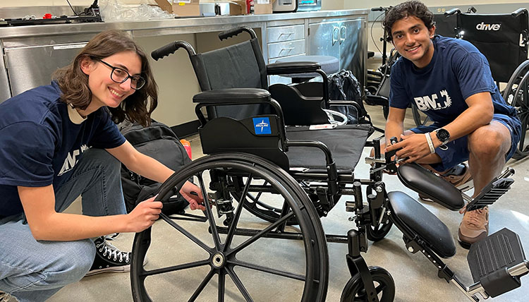 Two students assemble a manual wheelchair