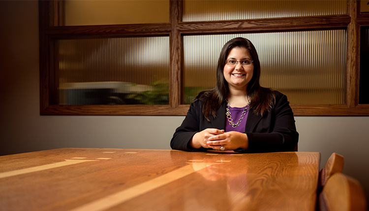 Law Professor Jessica Kiser sits in the Dean's Suite conference room
