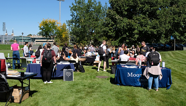 Students gather on the lawn South of the Law School to talk about different clubs and organizations they can be involved in. 