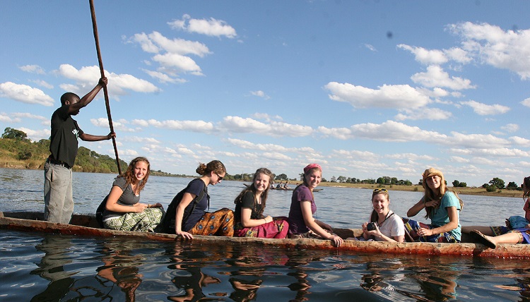 Study abroad students boating on the water.