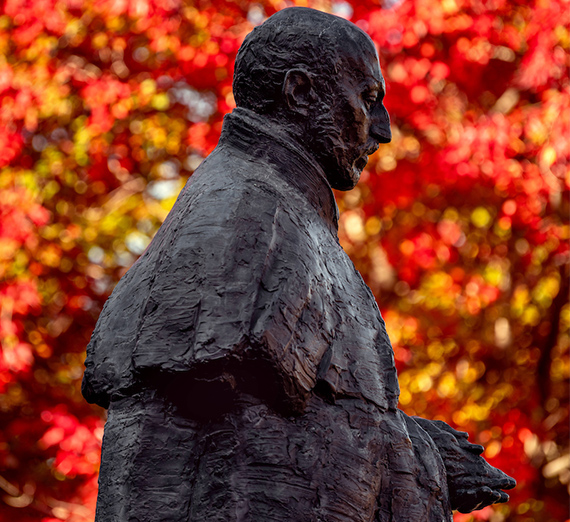 St. Ignatius of Loyola statue on Gonzaga University campus in autumn